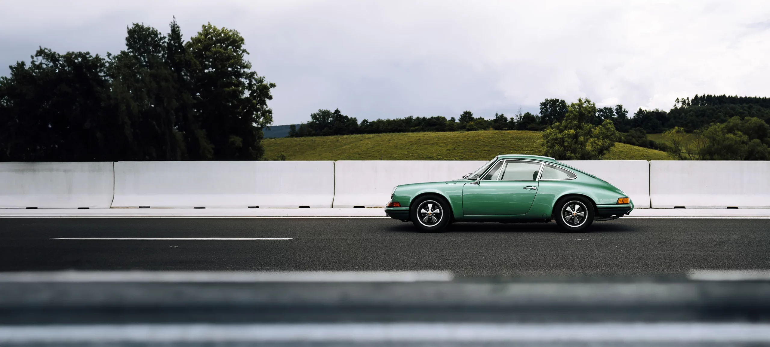 A Porsche 911 parked at the side of the road.